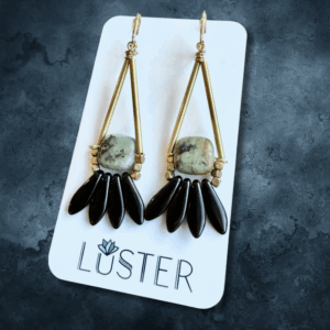 stone statement brass earrings on branded card