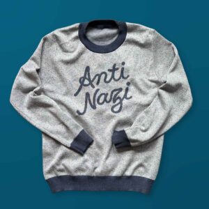 A gray sweater with blue script text that says Anti Nazi