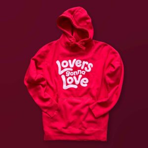 A red hoodie with text that says Lovers Gonna Love