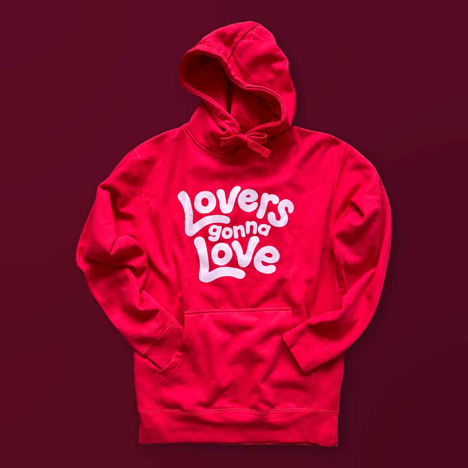 A red hoodie with text that says Lovers Gonna Love