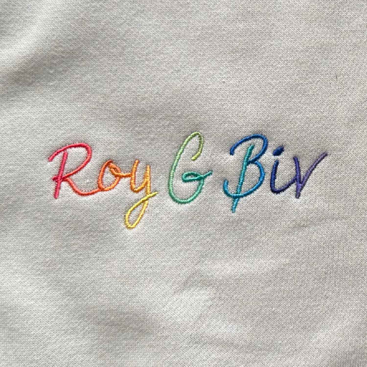 Closeup of embroidery detail that says Roy G Biv in a rainbow of color